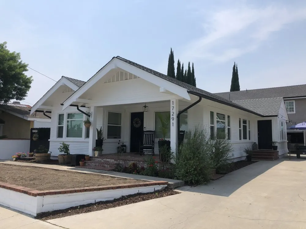 picture of the front yard of a house with new gutters